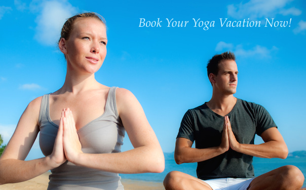 young couple sitting by the sea doing yoga