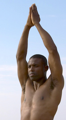 man standing in yoga pose