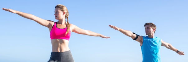 young couple in warrior yoga pose