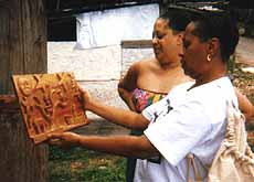 Chris and angela examine a piece of art.