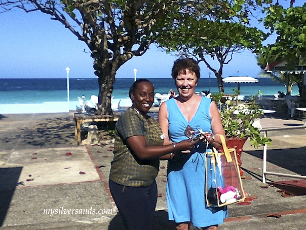 female guest with prize on patio with arlene at silver sands jamaica
