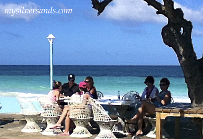 relaxing on the silver sands patio beside the Caribbean Sea