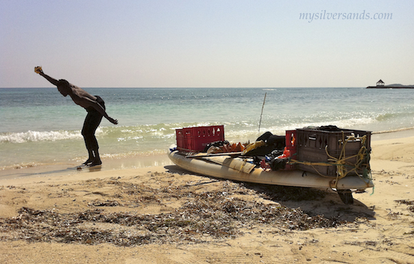 throwing the conch to the sand at silver sands beach jamaica