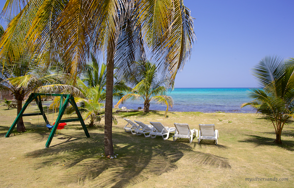 swings and lounge chairs on the beach front at endless summer