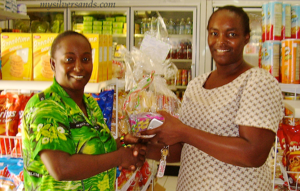 Lucille Jarrett of Hang Time Villa in Silver Sands receives her gift basket from Arlene of Villa Mart