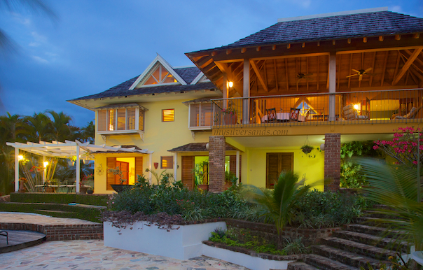 rock hill villa at night with bedroom 5 opened up to pool deck