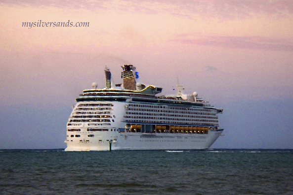 cruise ship, voyager of the seas, departing falmouth jamaica at sunset